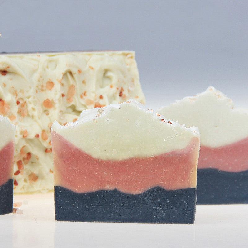 Multicolored natural bar soap with layers of white, pink, and dark blue