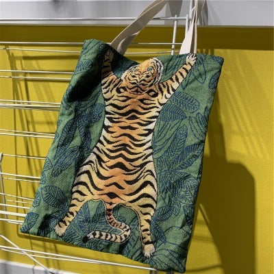 Green tote bag with tiger and leaf pattern