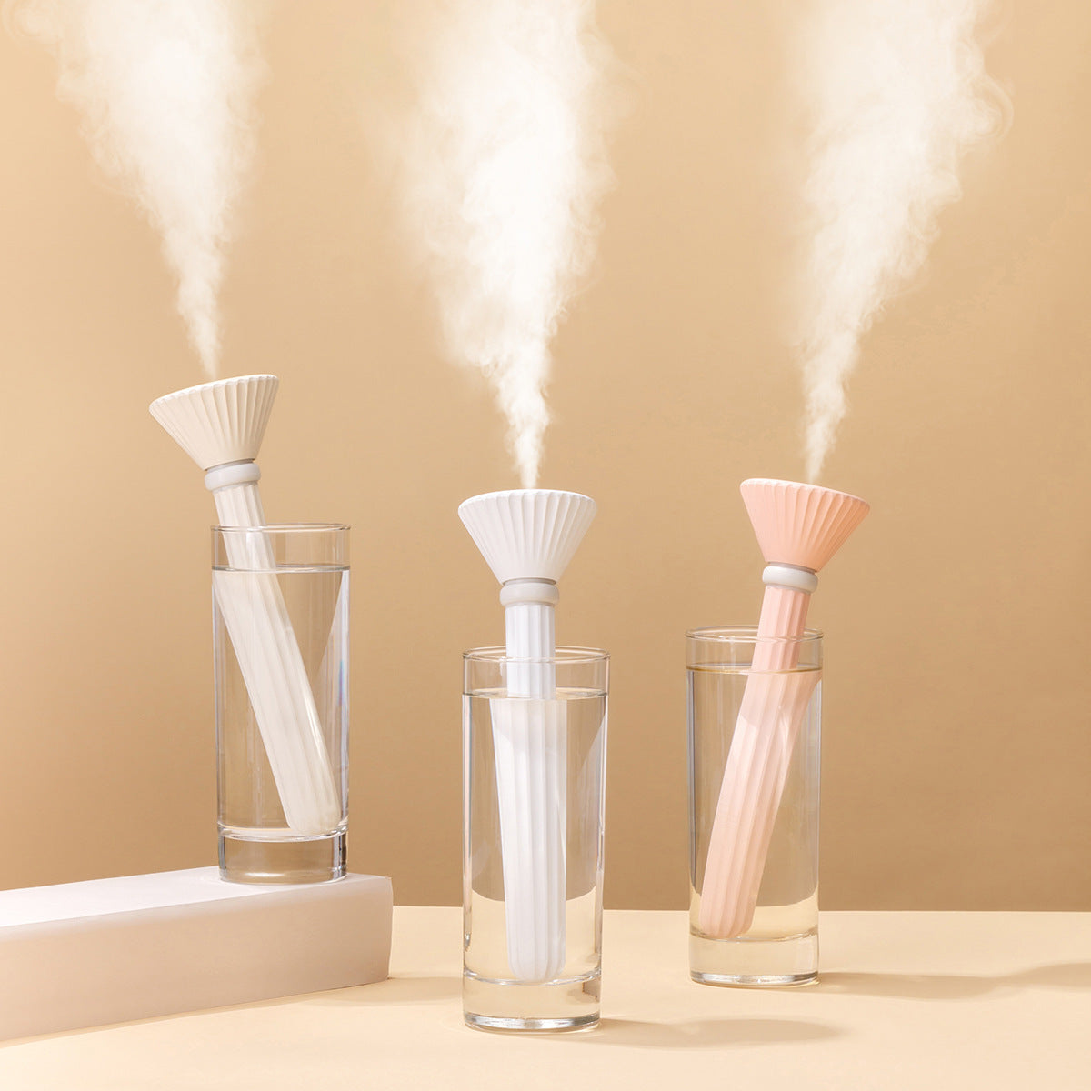 Portable cylindrical humidifier in white and pink for enhanced air quality