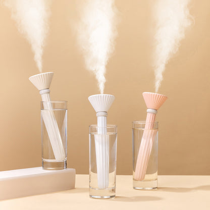 Portable cylindrical humidifier in white and pink for enhanced air quality