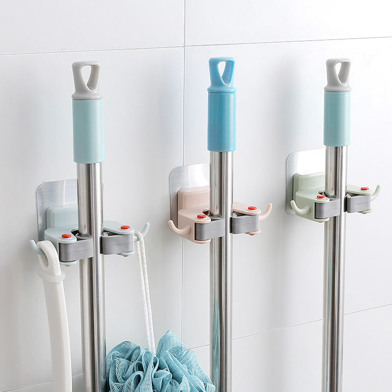 Wall-mounted mop and broom holder in light blue, gray, and beige