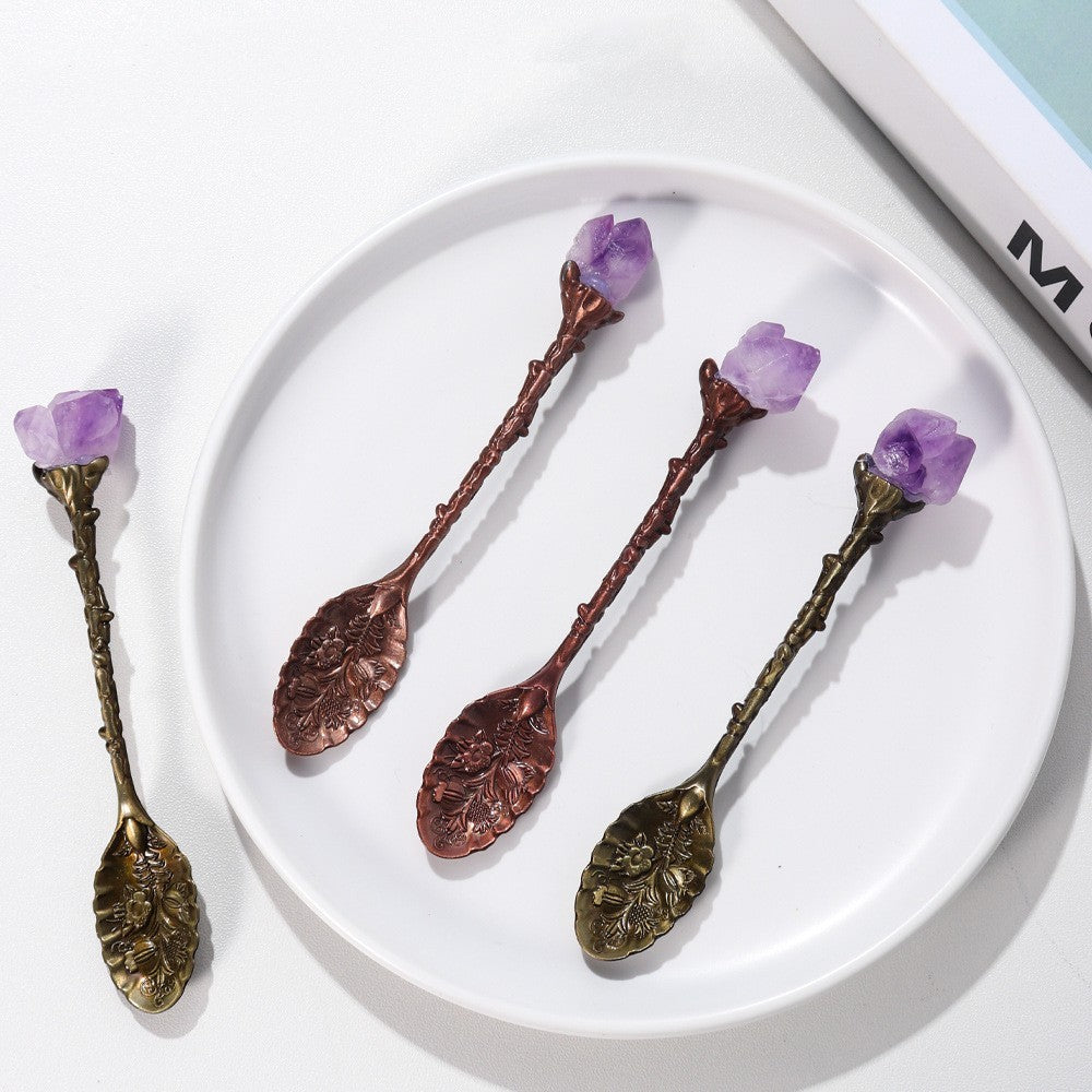 Ornate bronze and copper decorative spoons with purple stone accents