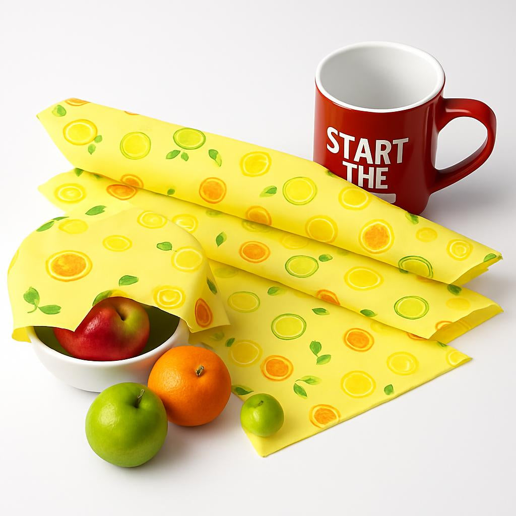 Yellow beeswax food wraps with fruit patterns in use