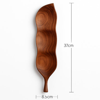 Leaf-shaped wooden serving tray in natural wood tone