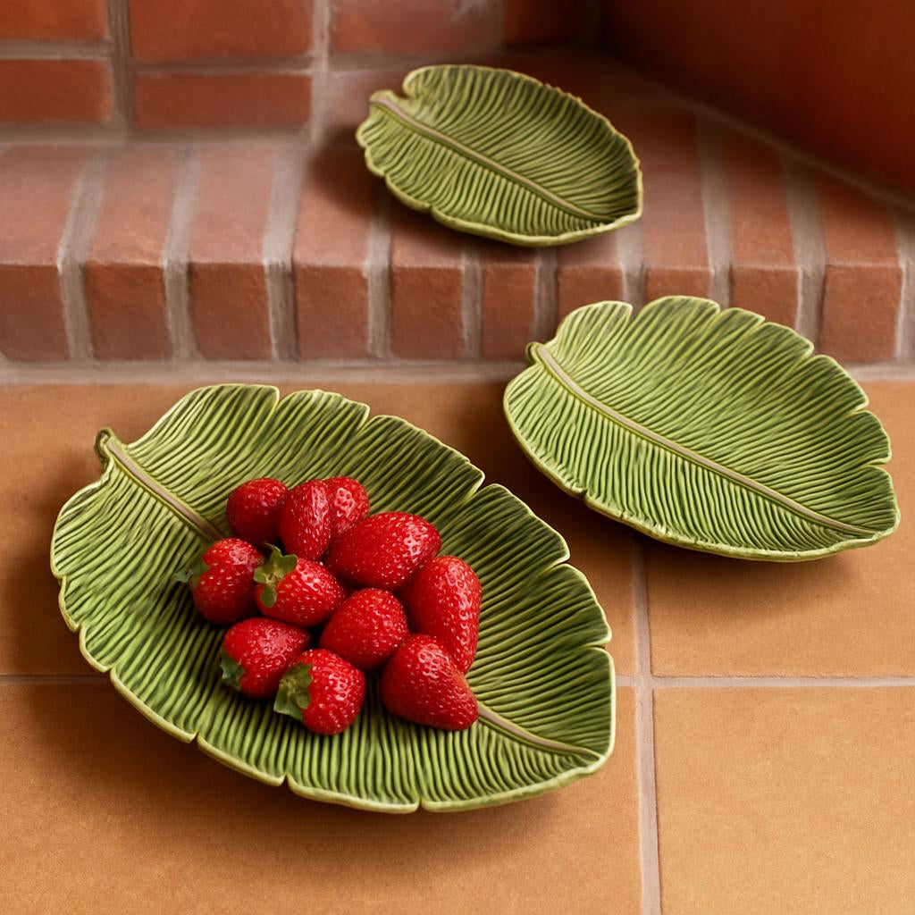 Green leaf-shaped ceramic serving plates with natural vein detailing